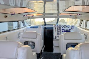 Helm station of 2000 Advantage Poker Run 40 with center console steering, dual Garmin displays, throttle controls, and win...
