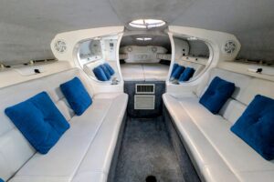 Helm station of 2000 Advantage Poker Run 40 with center console steering, dual Garmin displays, throttle controls, and win...