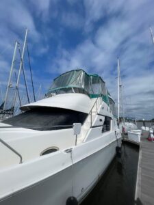 Silverton 392 Motor Yacht helm station with dual helm chairs, Garmin electronics, and forward cabin visibility through win...