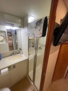 Silverton 392 Motor Yacht helm station with dual Garmin displays, leather captain's chair, and forward cabin visibility th...