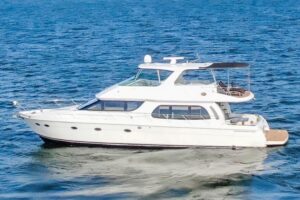 2005 Carver 560 Voyager 56-foot motor yacht shown in full starboard profile on calm water at Lake Dallas, Texas