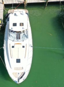 Stern view of 2006 Chris-Craft Roamer 40 cruiser with transom, swim platform, and dual outboard engines in Miami Beach.
