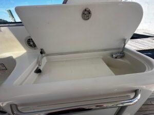 2006 Chris-Craft Roamer 40 cabin cruiser galley with stainless steel appliances and wood cabinetry.