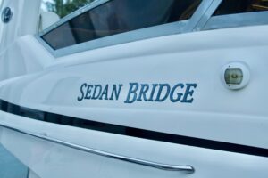 2006 Sea Ray 44 Sedan Bridge stern quarter profile showing transom, swim platform, and bridge deck layout docked in Miami