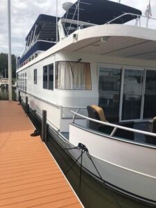 2007 Monticello 70 River Yacht stern quarter profile showing aft deck and upper deck structure at dock in Jamestown, Kentu...
