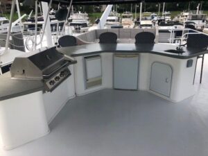 2007 Monticello 70 River Yacht mid-ship exterior hull detail showing waterline, fendering, and deck rail profile at Jamest...