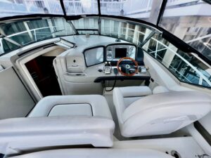 Sea Ray 38 Sundancer cabin cruiser helm station with dual helm seats, steering wheel, and instrument panel.