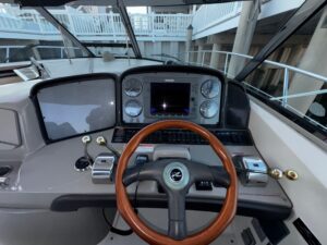 Sea Ray 38 Sundancer salon with curved seating, entertainment center, and cabin access.