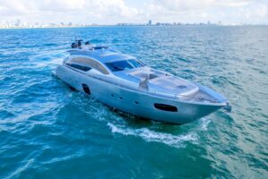 2013 Pershing 82 flybridge deck with helm seating, wraparound upholstery, and open-air layout overlooking the water in Miami