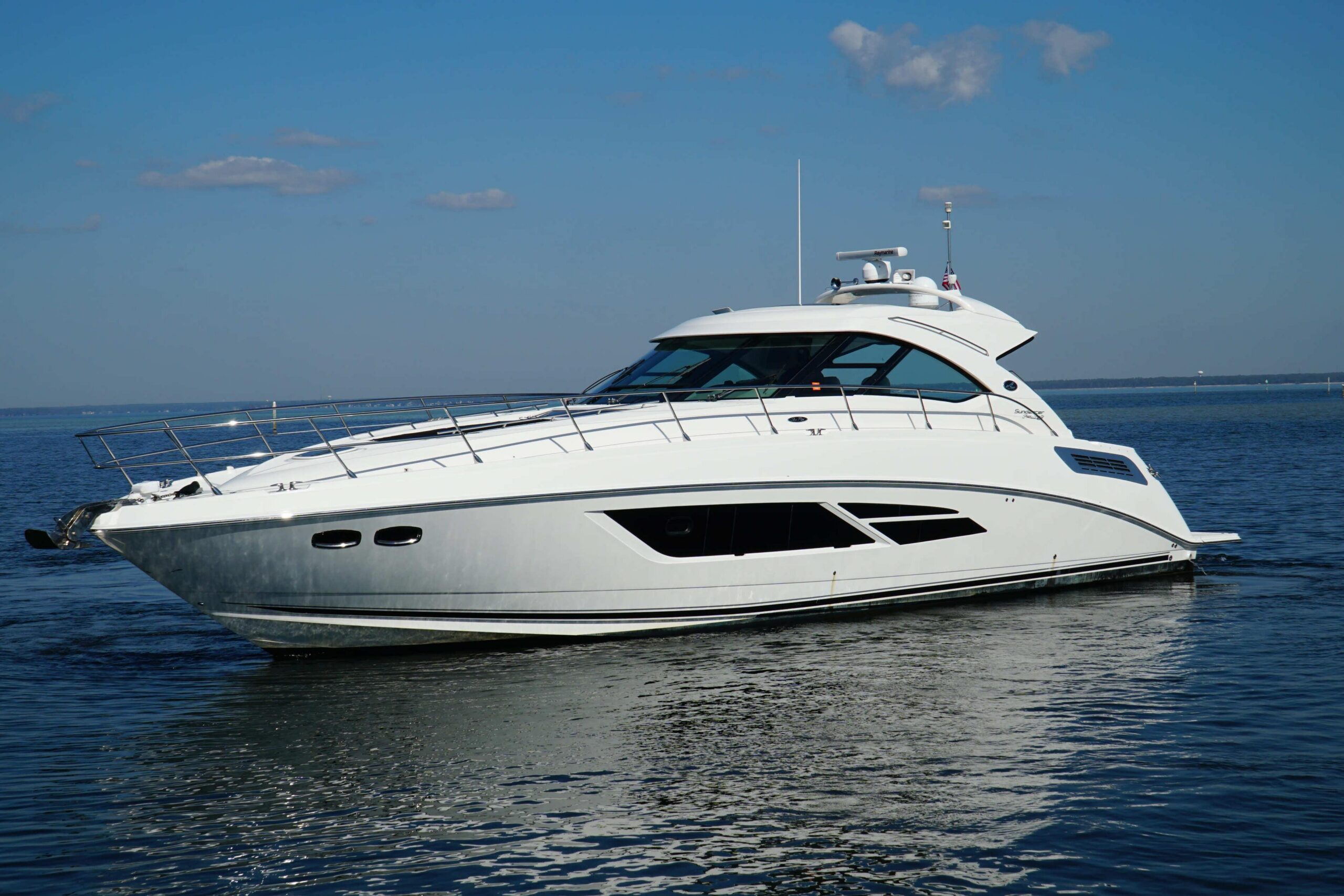 2014 Sea Ray Sundancer 540 54-foot express cruiser full port-side profile underway in open water, Destin Florida
