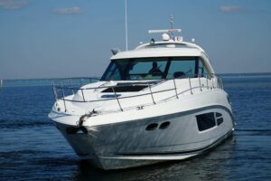 2014 Sea Ray Sundancer 540 stern and transom profile showing swim platform and aft deck layout, docked in Destin, Florida