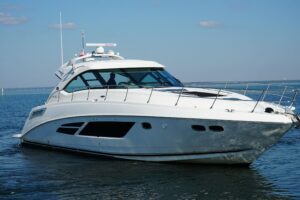 2014 Sea Ray Sundancer 540 stern and transom profile showing swim platform, hull lines, and aft deck layout docked in Dest...