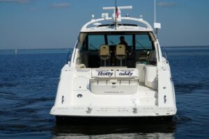 2014 Sea Ray Sundancer 540 main salon seating area with curved lounge upholstery, overhead lighting, and interior woodwork...