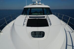 2014 Sea Ray Sundancer 540 main salon seating area with curved lounge upholstery, overhead lighting, and interior woodwork...