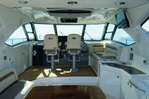 2014 Sea Ray Sundancer 540 main salon seating area with wraparound upholstered lounge, large windows, and interior cabin f...