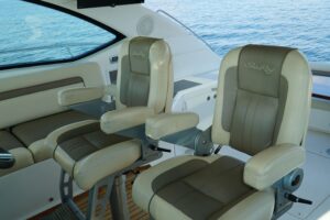 2014 Sea Ray Sundancer 540 main salon seating area with curved lounge upholstery, interior cabinetry, and overhead lightin...