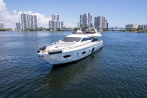 2015 Ferretti 750 flybridge deck seating area with wraparound upholstered lounge, helm station, and open sky views over Mi...