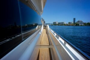 2015 Ferretti 750 flybridge deck seating area with wraparound lounge upholstery, helm station, and open water views from t...