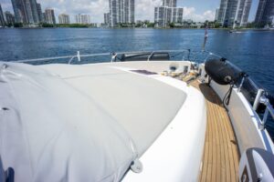 2015 Ferretti 750 flybridge deck seating area with wraparound upholstered lounge, helm station, and open sky views above M...