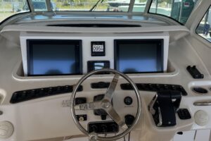2015 Grady-White Canyon 376 center console cockpit helm station with Garmin multifunction displays, dual helm seats, and o...
