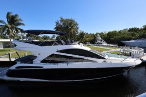 Sunseeker Manhattan 55 salon with cream upholstered seating, glass windows, and ambient lighting in Fort Lauderdale.