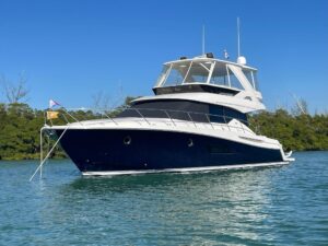 2020 Tiara Yachts F53 Flybridge bow view showing forward seating and cabin profile at Longboat Key.