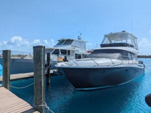 2020 Tiara Yachts F53 Flybridge bow seating area with forward-facing cushioned lounge and stainless steel railings overloo...