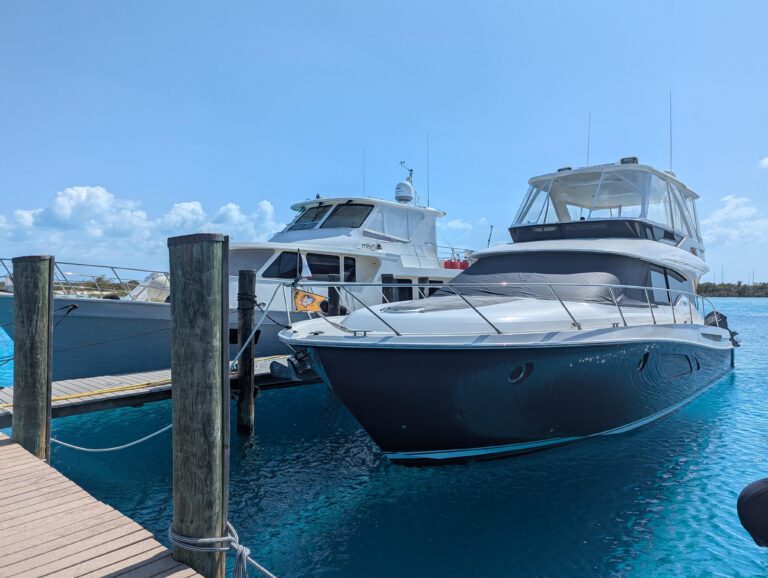 2020 Tiara Yachts F53 Flybridge bow seating area with forward-facing cushioned lounge and stainless steel railings overloo...