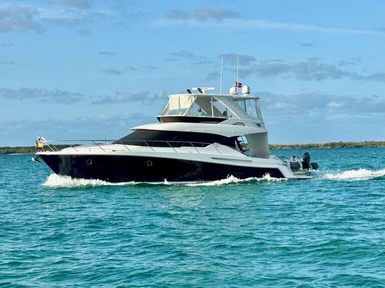 2020 Tiara Yachts F53 Flybridge helm station with dual Garmin displays, leather helm chair, and forward visibility through...