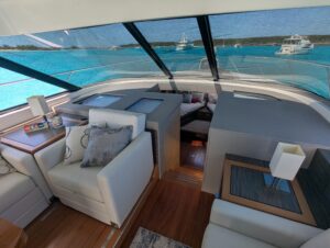 Tiara Yachts F53 Flybridge helm station with dual Garmin displays, leather helm seat, and forward visibility through winds...