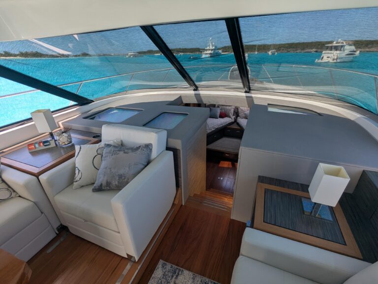 Tiara Yachts F53 Flybridge helm station with dual Garmin displays, leather helm seat, and forward visibility through winds...