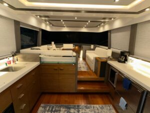 2020 Tiara Yachts F53 Flybridge flybridge helm station with dual helm chairs, Garmin electronics, and hardtop radar arch o...