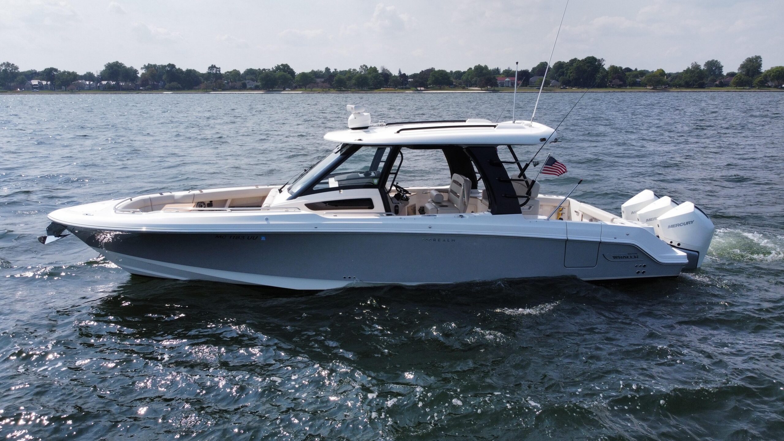 2022 Boston Whaler 350 Realm 35.5-foot center console yacht profile view showing white hull, hardtop, and helm station fro...