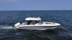 Boston Whaler 350 Realm center console helm with dual Garmin displays, steering wheel, and helm seating.