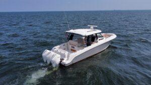 Boston Whaler 350 Realm helm station with dual Garmin displays, center console steering, and forward cabin visibility thro...