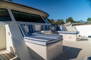 2022 Marlow Voyager 100 Series motor yacht helm station with dual Garmin displays, leather helm chair, and forward salon v...