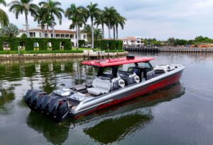 2022 Nor-Tech 50 Sport center console yacht profile view showcasing aggressive hull design and hardtop tower in Miami Beach.