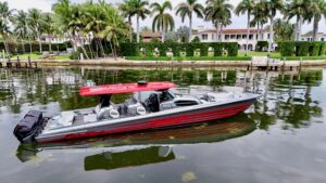 Nor-Tech 50 Sport center console helm with dual Garmin displays, leather helm seat, and forward windscreen in Miami Beach.