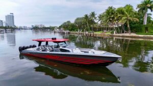Nor-Tech 50 Sport center console helm station with dual Garmin displays, leather helm seat, and stainless steel steering w...