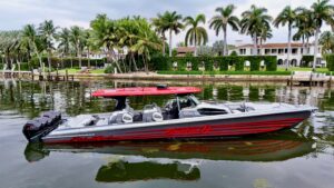 Nor-Tech 50 Sport center console helm station with dual Garmin displays, stainless steel wheel, and forward visibility ove...