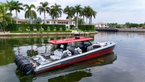 Nor-Tech 50 Sport helm station with dual Garmin displays, center console steering, and forward visibility toward the bow.