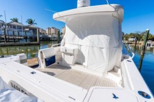 2023 Intrepid 438 Evolution center console cabin cruiser mid-ship profile showing hardtop, outriggers, and twin-level deck...