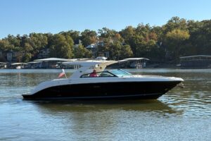Sea Ray SLX 400 helm station with dual Garmin displays, steering wheel, and center console controls overlooking the windsh...