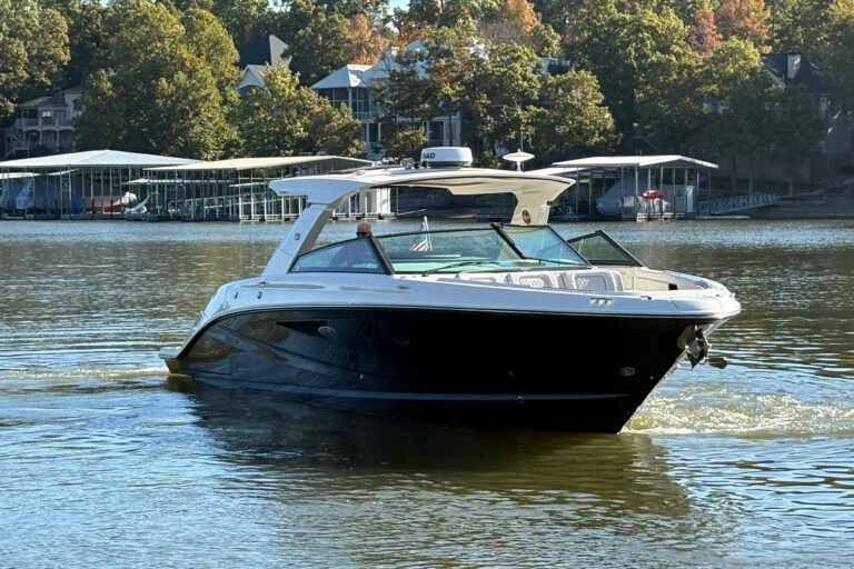 Sea Ray SLX 400 helm station with dual Garmin displays, leather helm seat, and center console steering wheel.