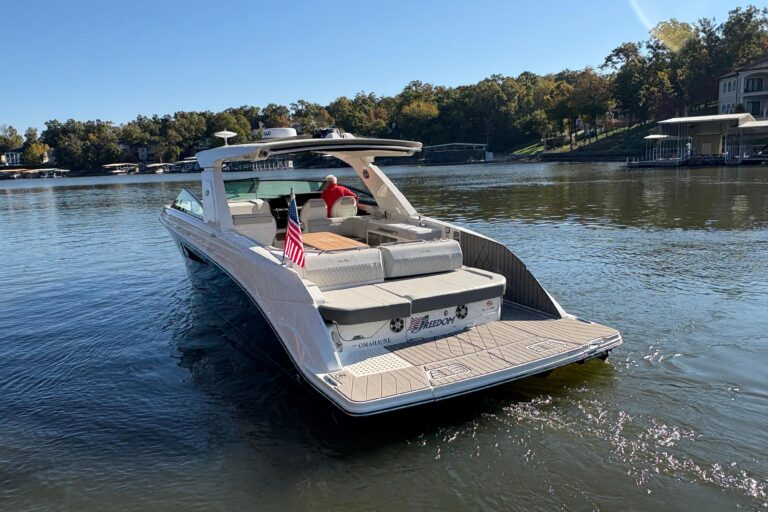2023 Sea Ray SLX 400 cabin cruiser helm station with dual Garmin displays and center console steering.