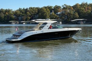 Sea Ray SLX 400 cabin cruiser with open bow seating and windshield viewed from starboard side.