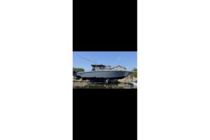 2024 Fountain 38 SC center console helm station with dual Garmin displays, steering wheel, and throttle controls overlooki...