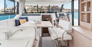 Beneteau Swift Trawler 41 Fly bow seating and forward cabin entry with teak accents and curved windscreen.