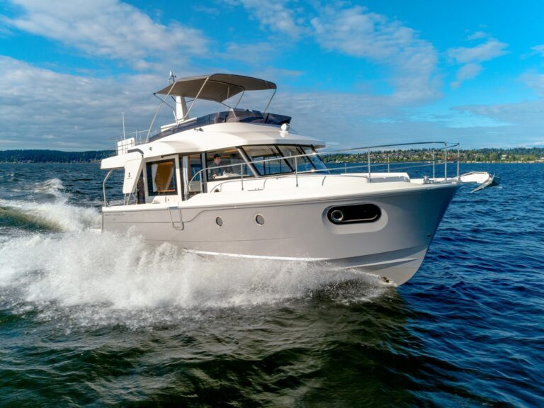 Beneteau Swift Trawler 41 Fly helm station with dual Garmin displays, leather helm seating, and teak accents in the piloth...