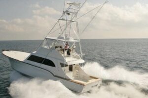 Buddy Davis 58 Sportfisherman helm station with dual Garmin displays, leather helm seat, and center console steering wheel.
